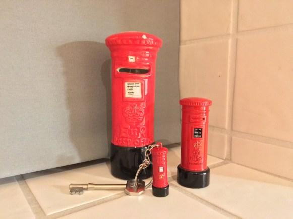 Miniature red pillar boxes with a set of house keys